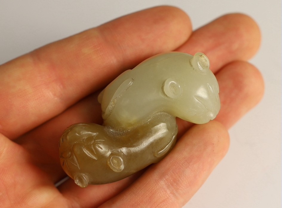 A Chinese pale celadon and brown jade group of two cats, 19th century, 5.1cm, wood stand, tiny chips